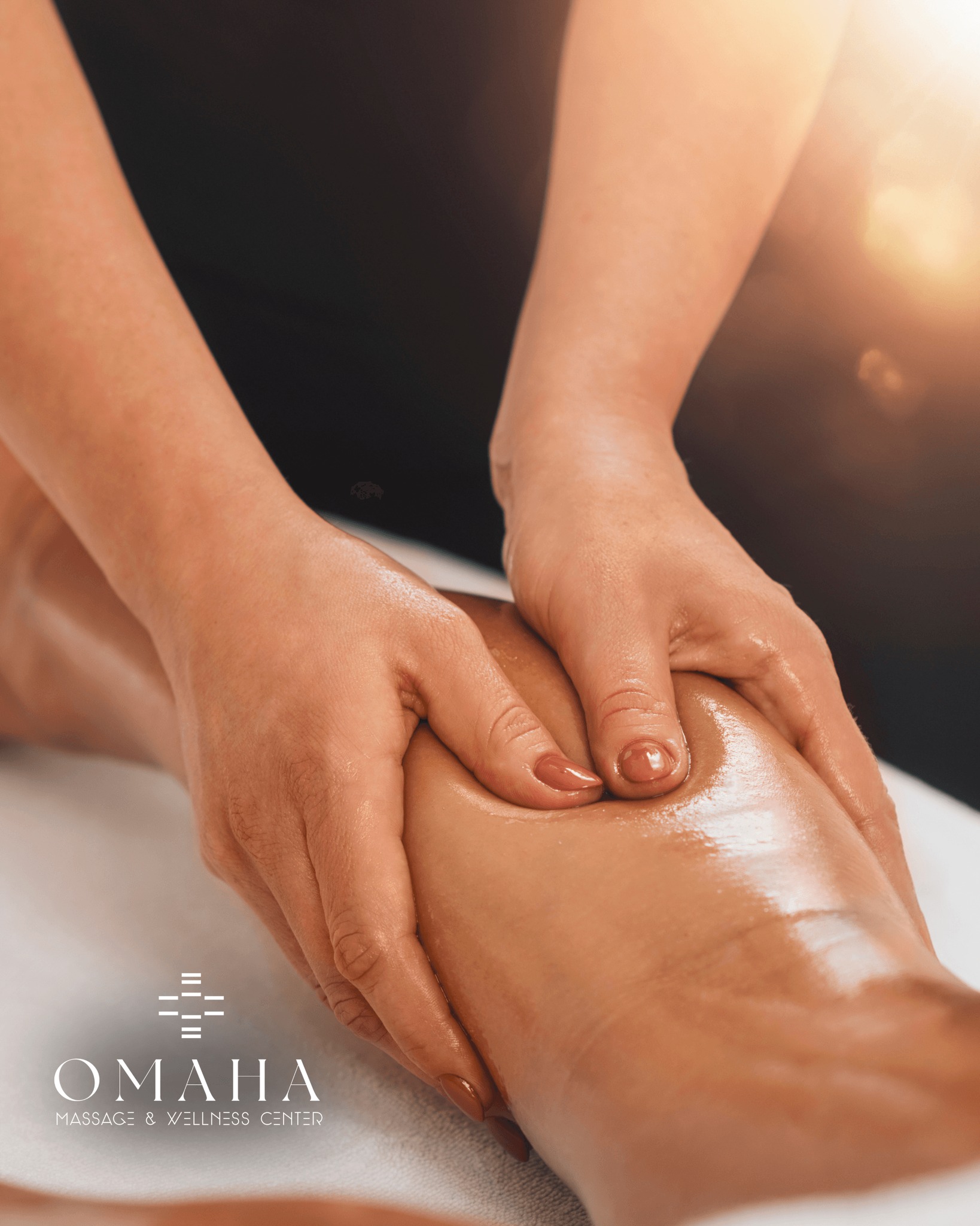 Therapist performing deep tissue massage Omaha on a client’s leg, showing focused pressure and therapeutic techniques at Omaha Massage & Wellness Center.